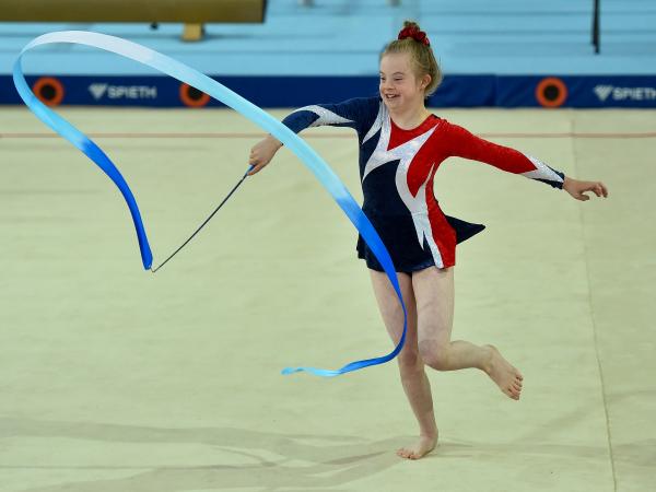 Special Olympics gymastic performing rhythmic gymnastics with ribbon