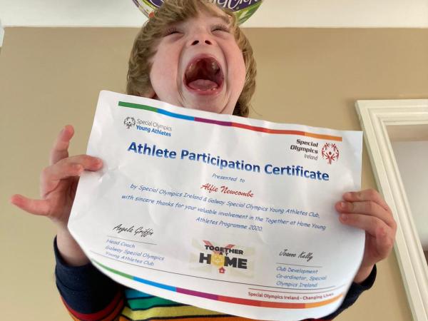 Young Athlete celebrates with certificate