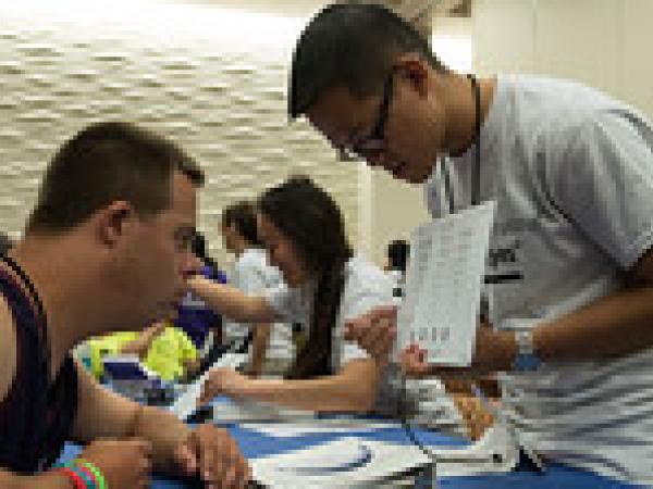man shows medical form to special oylmpics athlete