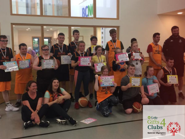 19 people hold certificates and smile to camera