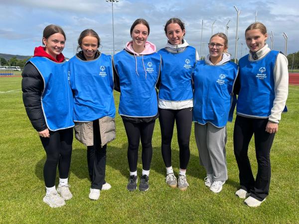 This image shows TY Student Volunteers smiling for a picture with arms around each other.