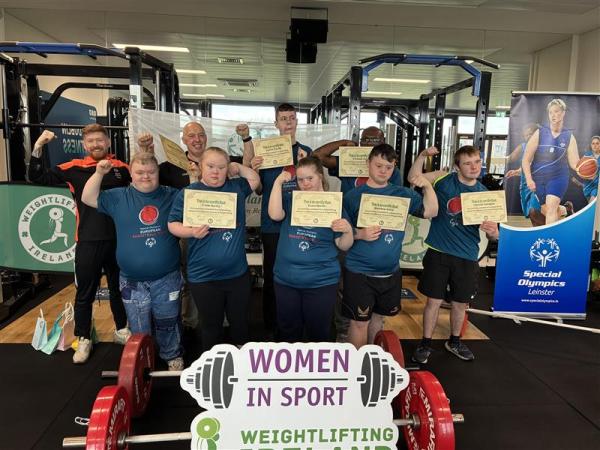 This image shows a full team photo of athletes with certificates - Weight Lifting Programme.