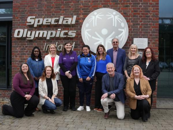 Group photo of Special Olympics Ireland staff, athletes, and representatives from the Golisano Foundation and Special Olympics international organisations standing outside the Special Olympics Ireland headquarters.