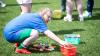 Young athlete places toys in basket