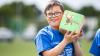 Young athlete poses with building block