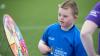 Young Athlete plays with health education spinning wheel