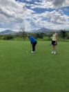 Tara Leech competes in the putting competition with Captain Sarah Courtney