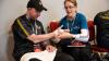 Athletes Gary Burton and Lorraine Whelan practice bandaging techniques in a First Aid workshop at the All Ireland Athlete Leadership Forum 2024