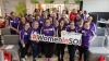 Over 30 female athlete participants in the Healthfest 2026 event pose for a photo holding a sign that says "Women in SOI"