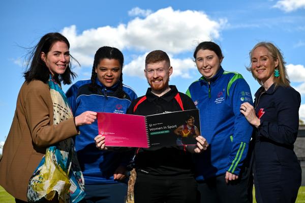 four women and a man read the Women in Sport action plan