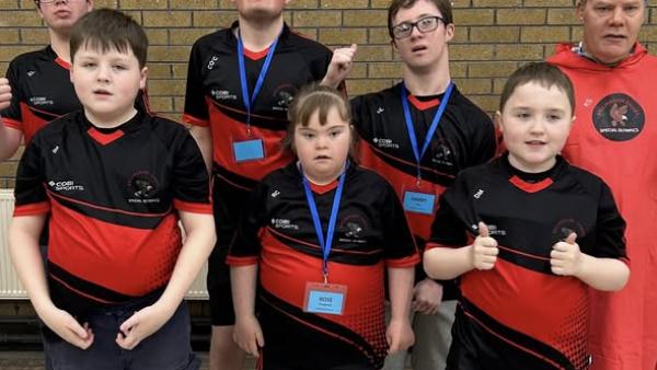 This image shows a swimming gala team photo - With ribbons and smiles.