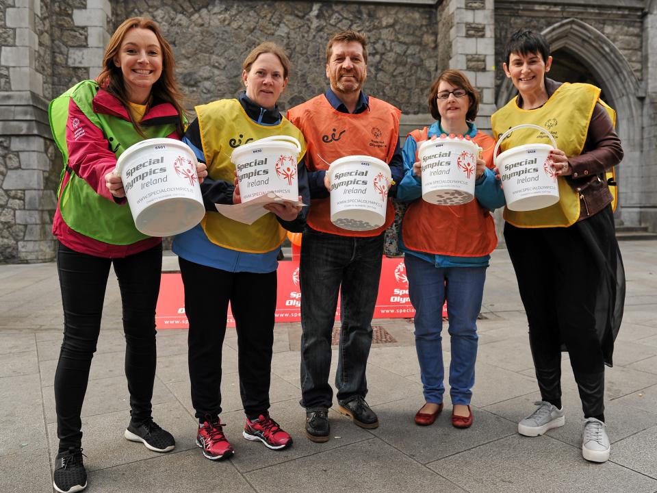 Volunteers collecting money with collection buckets