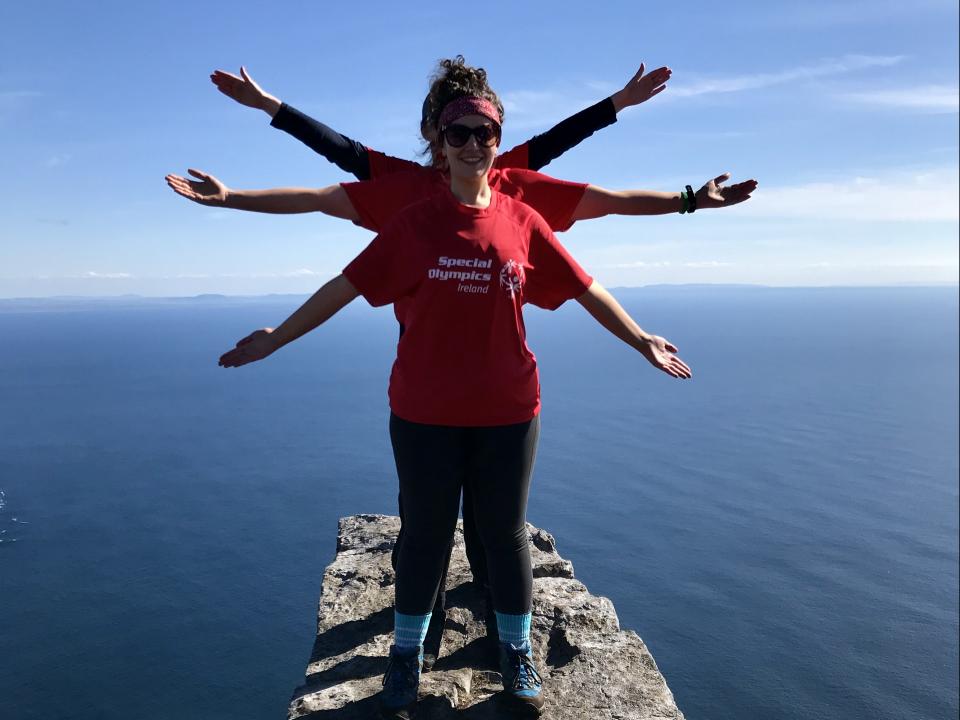 Three girls stand and pose one peak during 5 peaks challenge