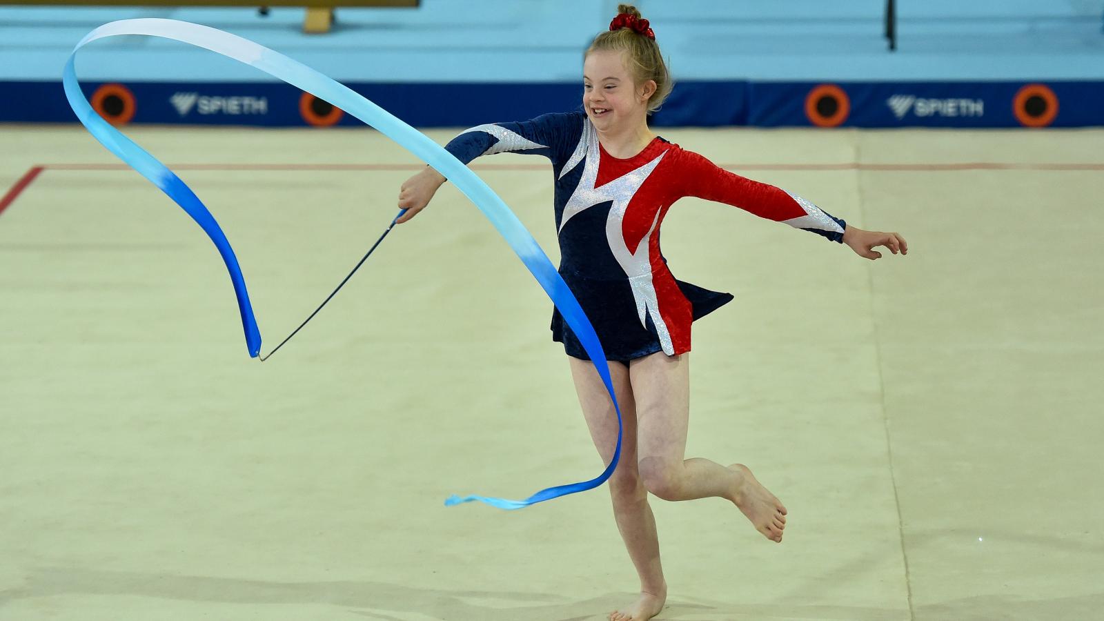 Special Olympics gymastic performing rhythmic gymnastics with ribbon