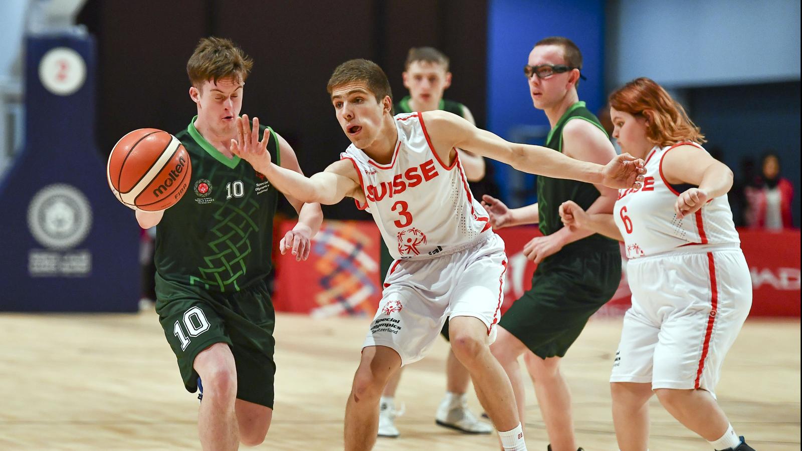 Players dribbling basketball